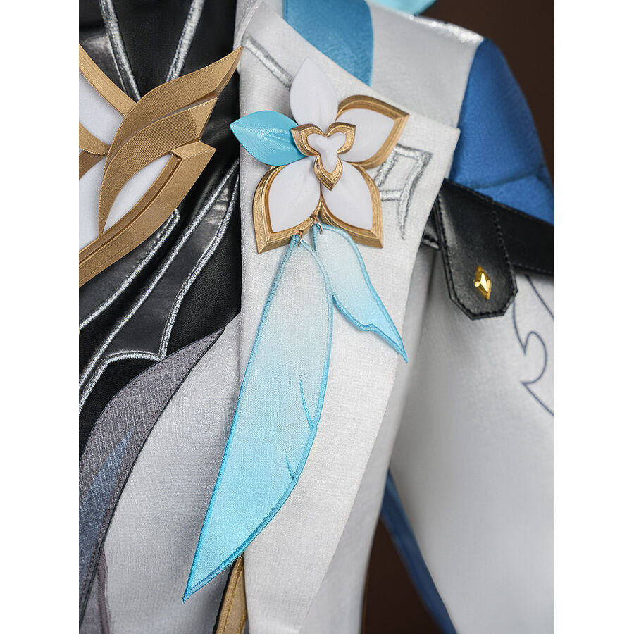 Detail of white flower brooch with gold trim and blue fabric ribbons on the Aether cosplay costume front