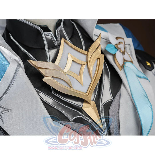 Macro shot of the gold chest emblem on Aether cosplay costume, showing detailed diamond-shaped metallic ornament