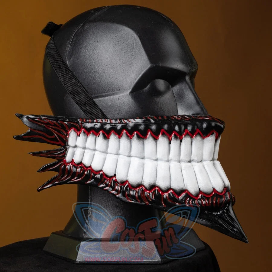 A mannequin dons the Body Party-styled helmet, its menacing jaw, sharp teeth, and dark-red accents creating a stark, eerie vibe against the warm backdrop.