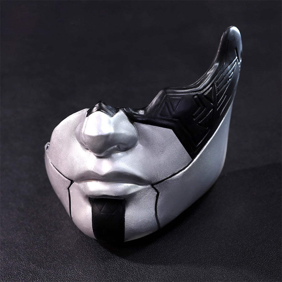 Close-up detail of decorative white and silver mask accessory included with Alicia cosplay costume, featuring sculptural design with black accents