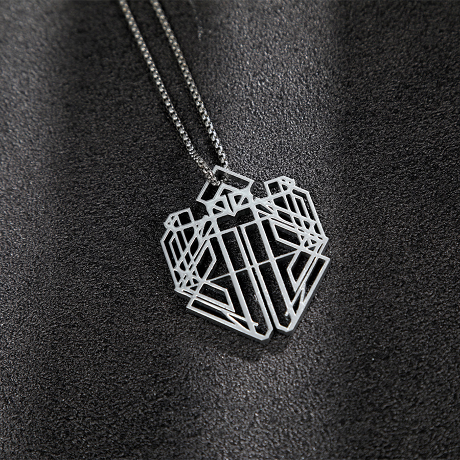 The necklace is entirely silver and has a complex geometric shape.