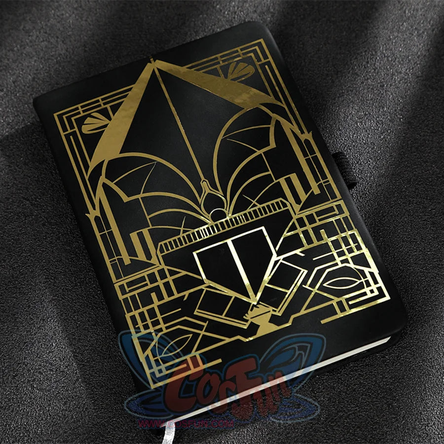 The notebook has a black cover with gold geometric patterns.