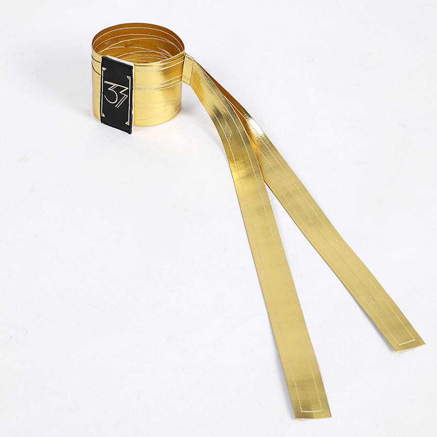 A gold PU leather armband with a black badge bearing the number &quot;33&quot;.