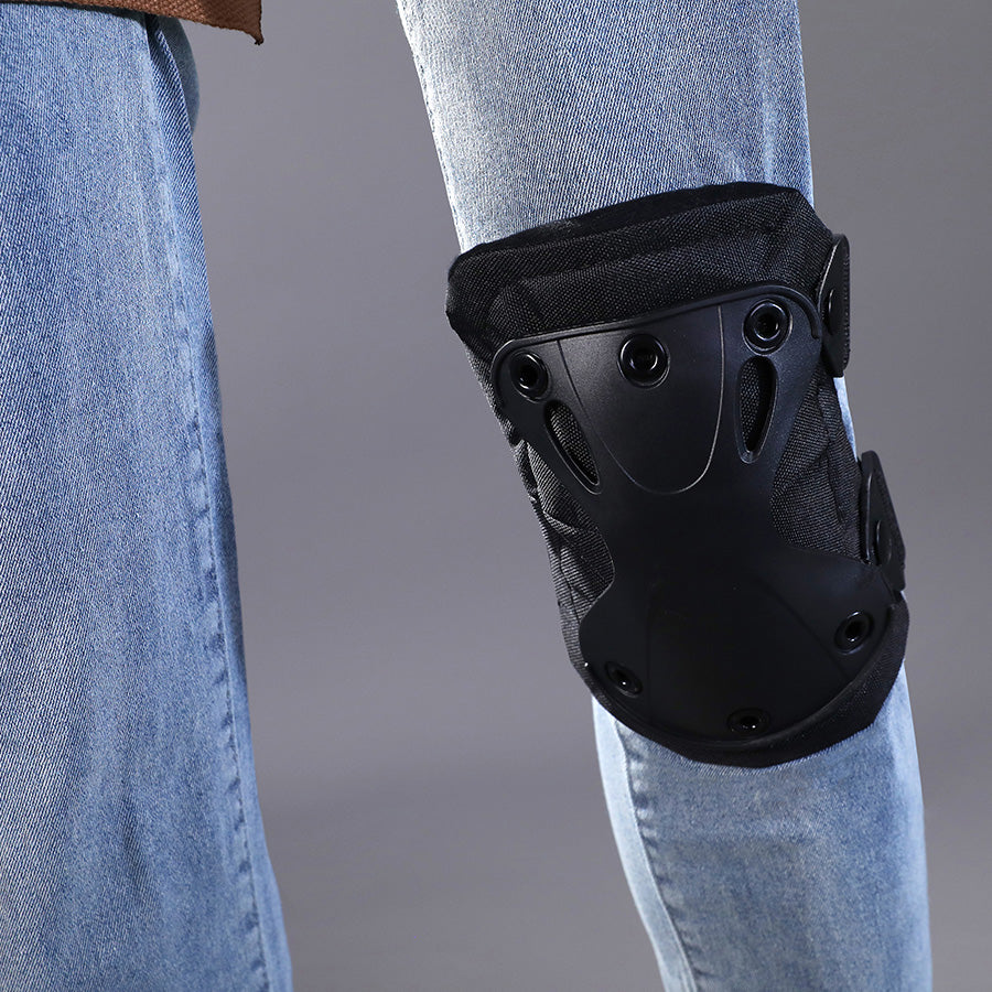 Close-up detail of Kyle Crane cosplay costume black protective knee pad with hard shell design and adjustable straps