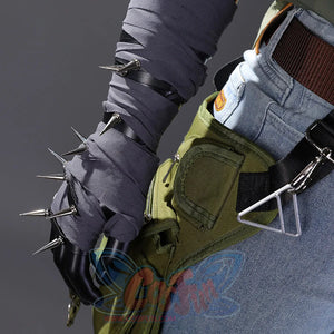 Detail shot of Kyle Crane cosplay costume wrapped forearm with spike embellishments, black gloves, and green waist bag with carabiner