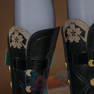 Evanescia cosplay black leather knee guards with gold glitter sakura and crescent moon ornaments over grey fishnet stockings.
