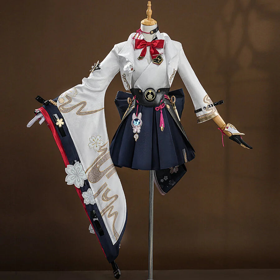 Evanescia cosplay featuring white jacket with gold embroidery, navy hakama skirt, red bow, and decorative sword accessories on mannequin