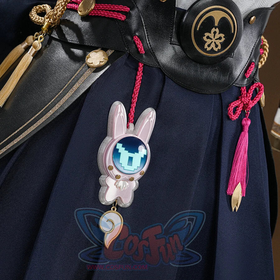 Evanescia cosplay navy hakama with pink rabbit charm, gold coin charms, pink tassel, and black belt with sakura emblem.