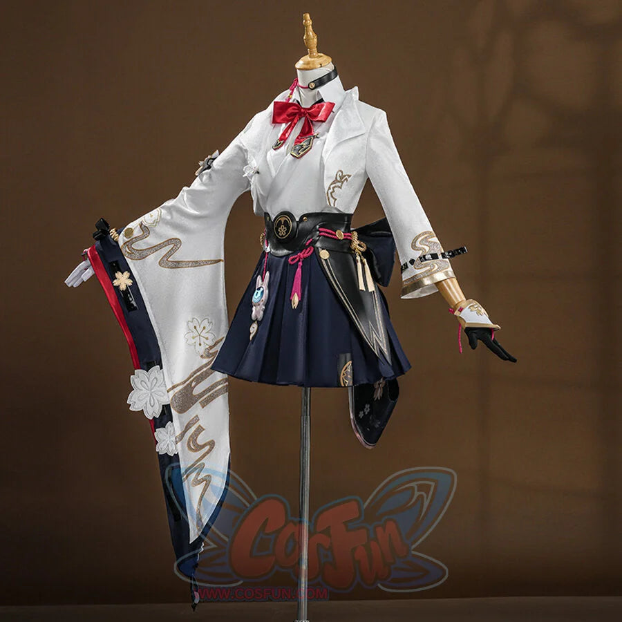 Evanescia cosplay featuring white jacket with gold embroidery, navy hakama skirt, red bow, and decorative sword accessories on mannequin