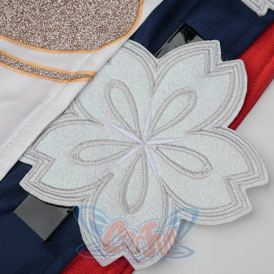 Evanescia cosplay large white glitter sakura applique close-up against white jacket with gold embroidery and navy-red fabric.