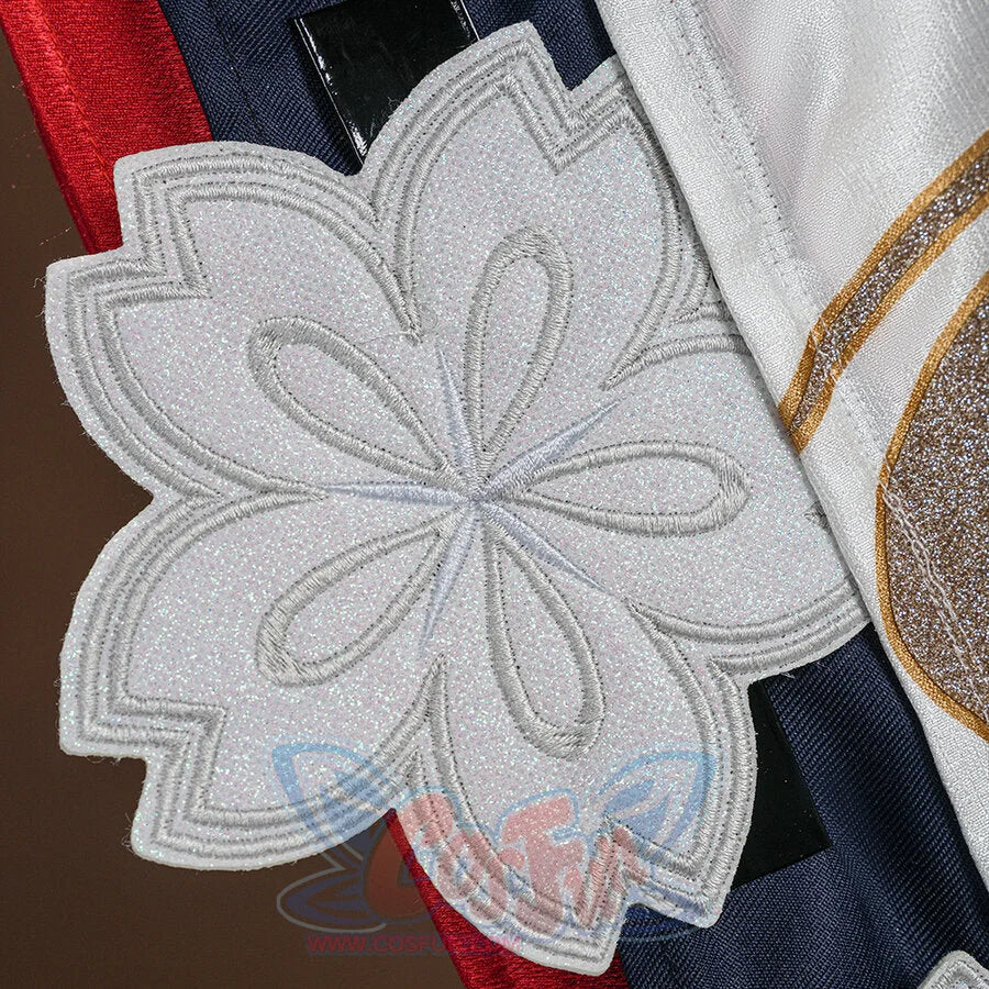 Evanescia cosplay large white glitter sakura flower applique on the costume, with gold trim and navy fabric with red stripe.
