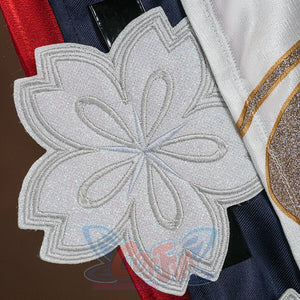 Evanescia cosplay large white glitter sakura flower applique on the costume, with gold trim and navy fabric with red stripe.