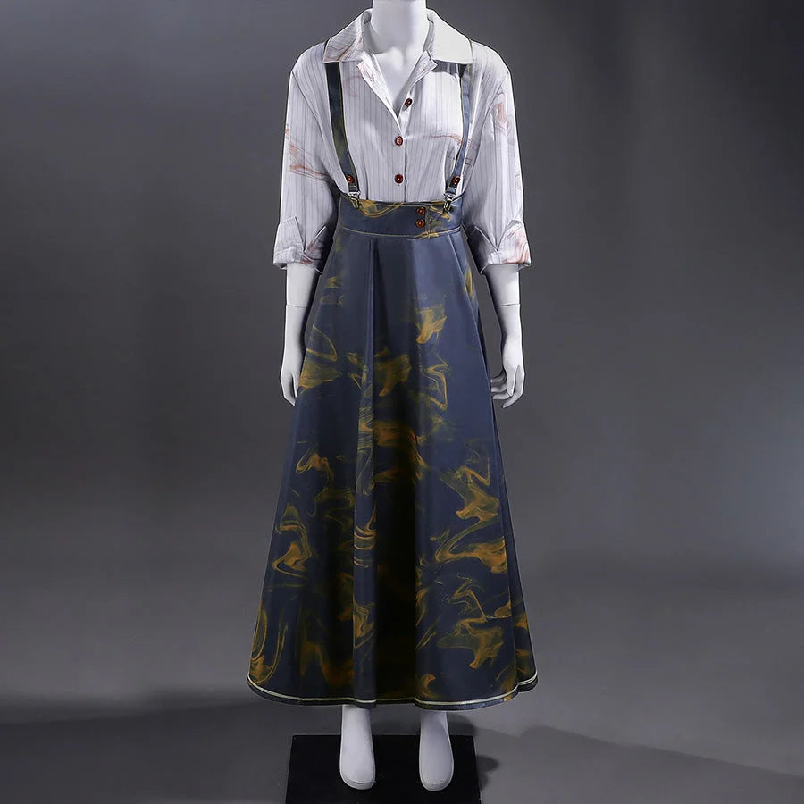 Full view of Clea Dessendre cosplay costume featuring a white striped shirt with button details and a blue suspender skirt adorned with golden bird patterns