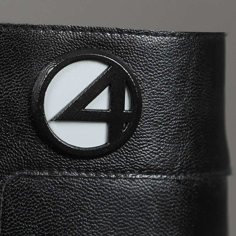 Sue Storm cosplay shoes detail close-up of Fantastic Four logo medallion with textured boot surface