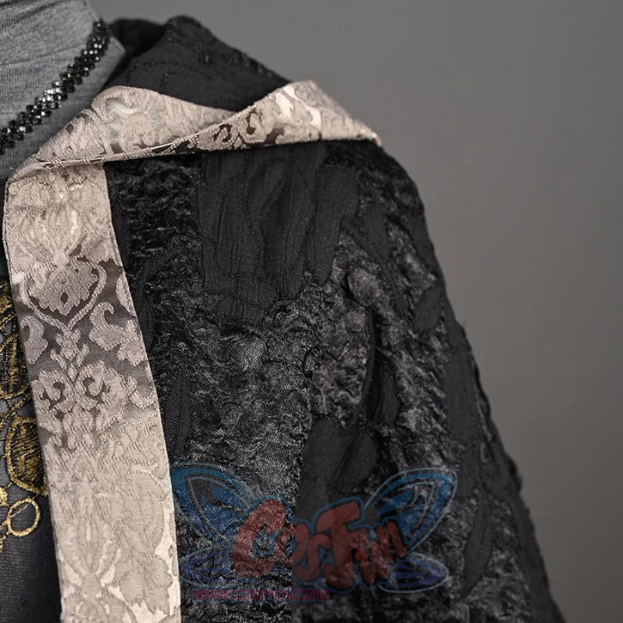 Features a close-up detail of the black, textured cloak with a decorative, patterned trim from the cosplay outfit.