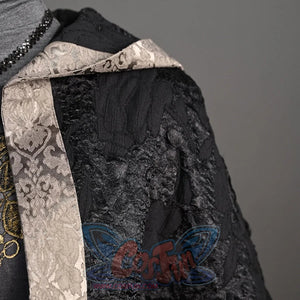 Features a close-up detail of the black, textured cloak with a decorative, patterned trim from the cosplay outfit.