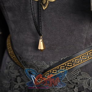 Shows a close-up of a gold pendant and the intricately designed belt on the dark cosplay costume.