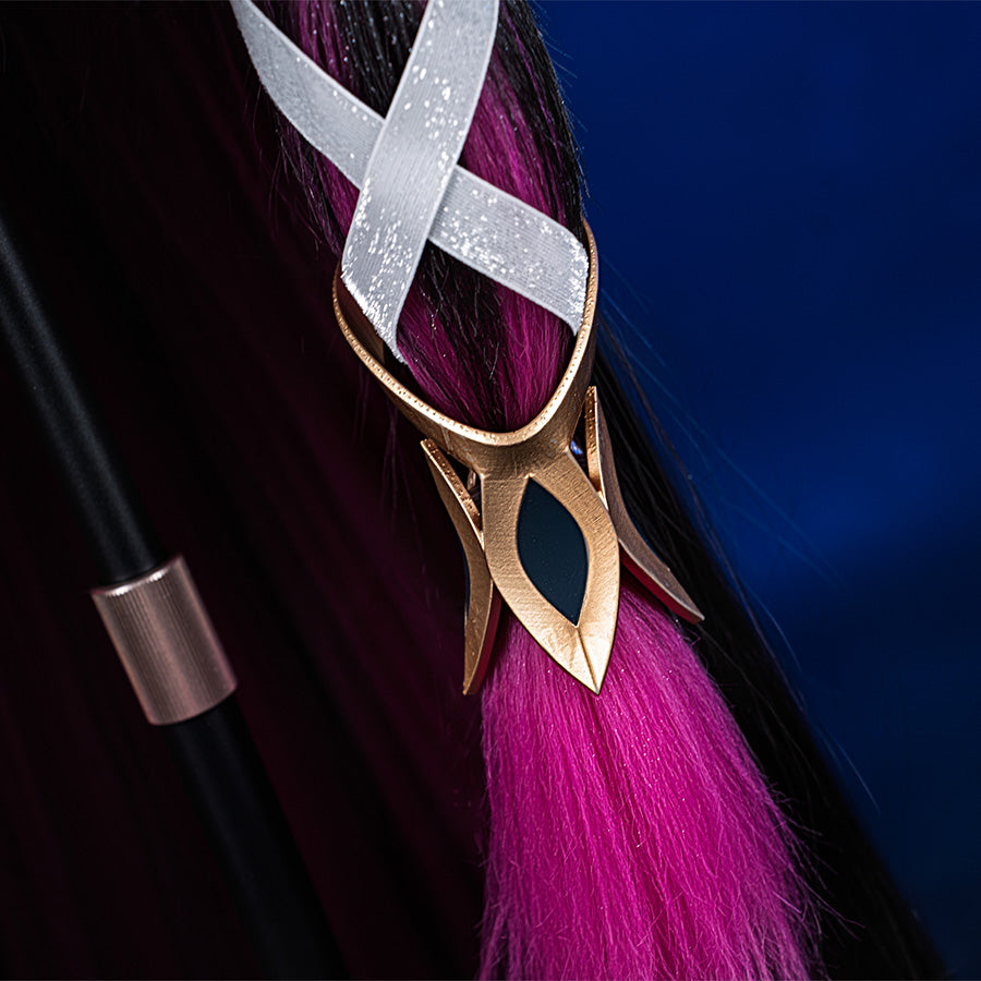 Columbina cosplay costume earring detail featuring gold frame, white ribbon, and magenta tassel