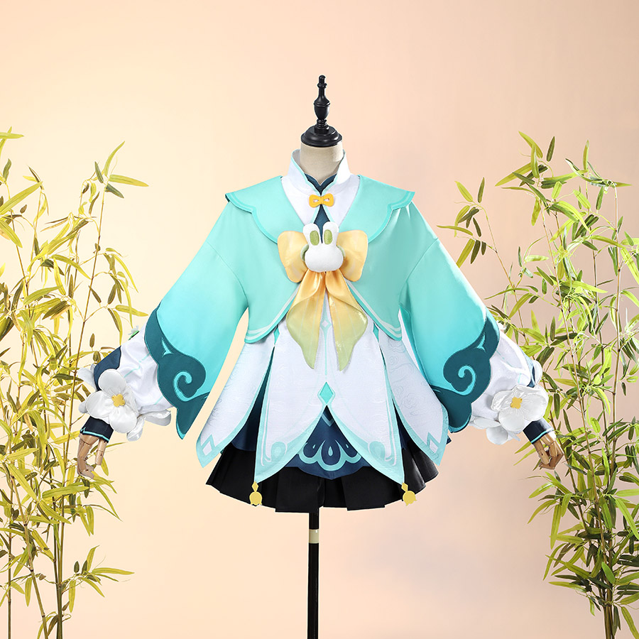Genshin Impact Yaoyao cosplay dress balances teal layered bodice against black ruffled skirt and floral arm cuffs.