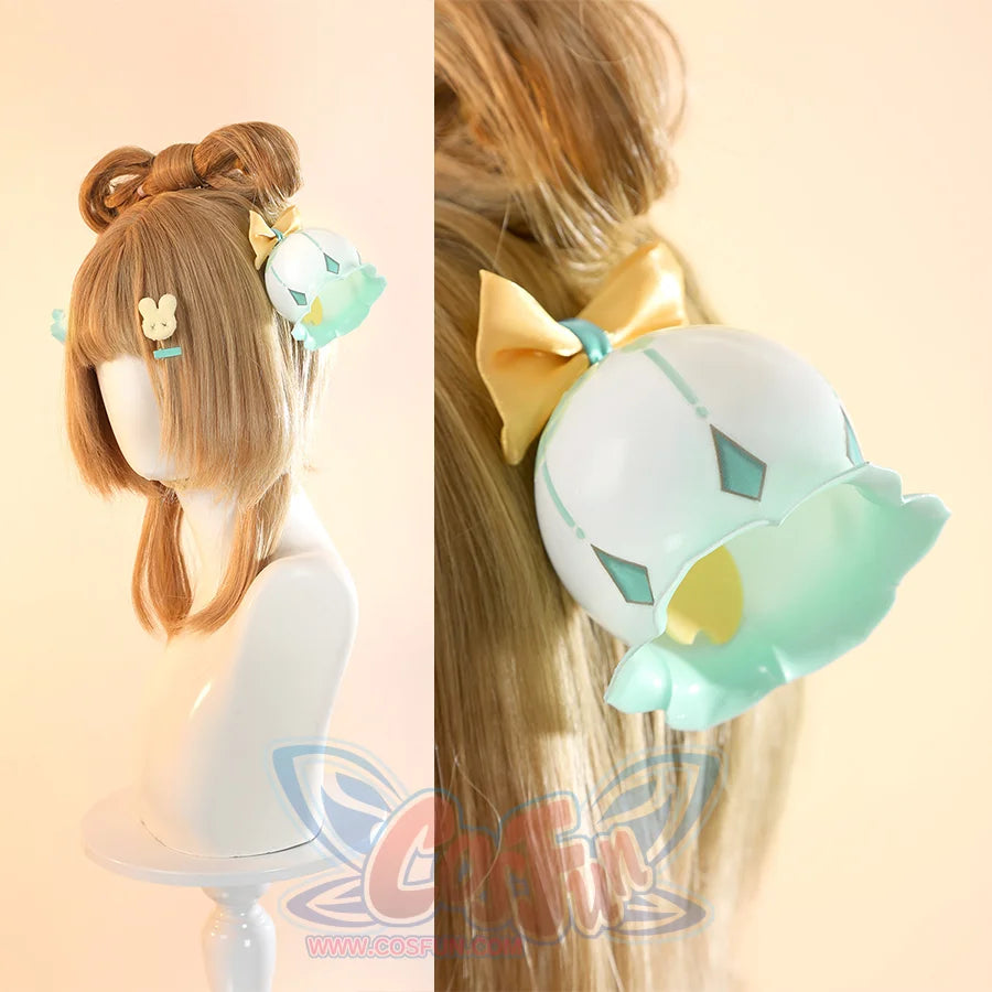 Genshin Impact Yaoyao cosplay headwear pairs honey-brown bun wig alongside teal bell headpieces and star charms.