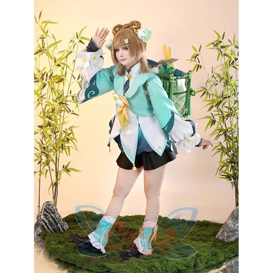 Genshin Impact Yaoyao cosplay outfit pairs teal jacket over black pleated skirt and floral leg coverings.