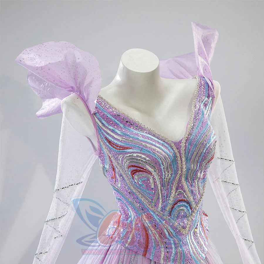 Close-up of Glinda cosplay dress bodice with colorful swirl embroidery and sheer flutter sleeves