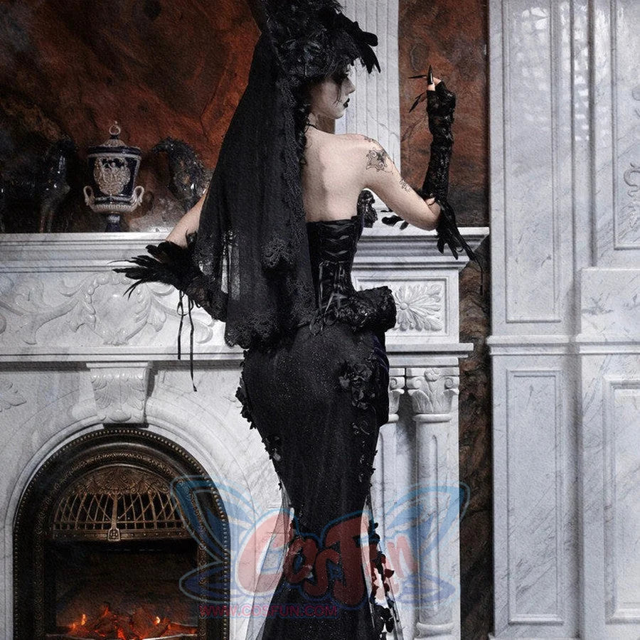 Back view of a model in a gothic black mermaid skirt with a long lace veil, standing near a marble fireplace.