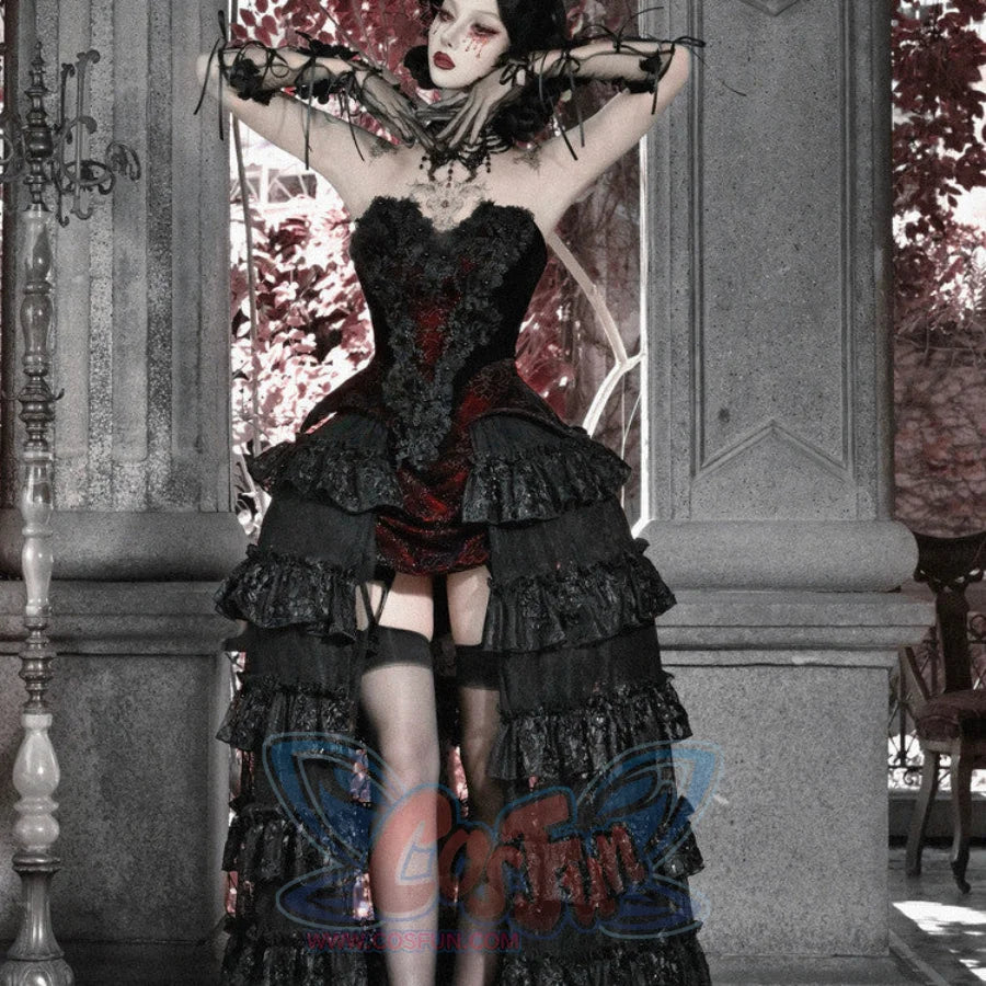 Model with arms raised in gothic black corset bustier top, red brocade, tiered ruffled skirt, and garter stockings.