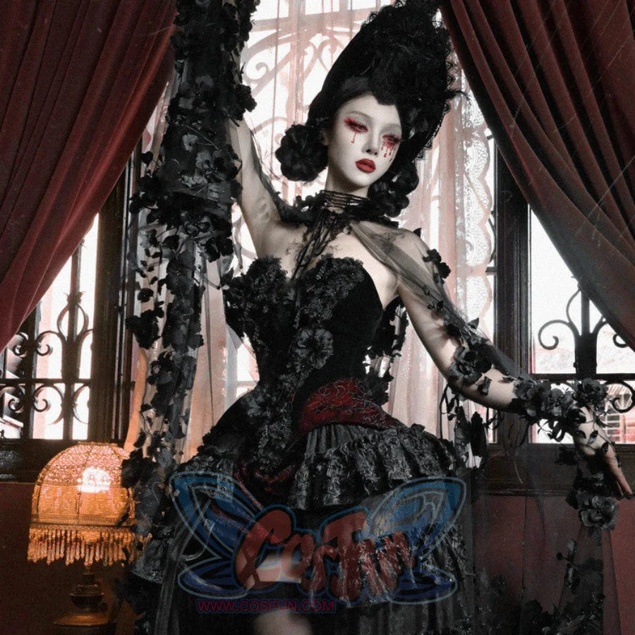 Model in black corset bustier top with red brocade panel, floral ruffled skirt, dramatic gothic headpiece, arm raised.