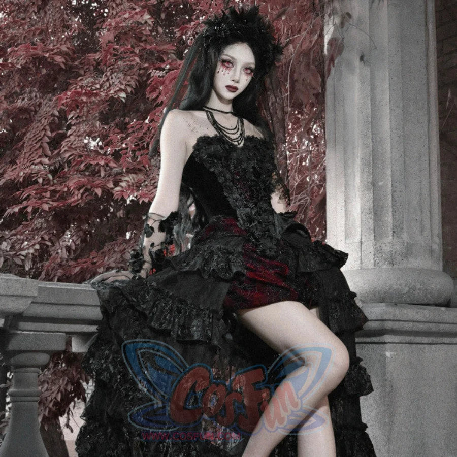 Model seated in gothic black corset bustier top, ruffled skirt, layered necklaces, and dark floral headpiece.