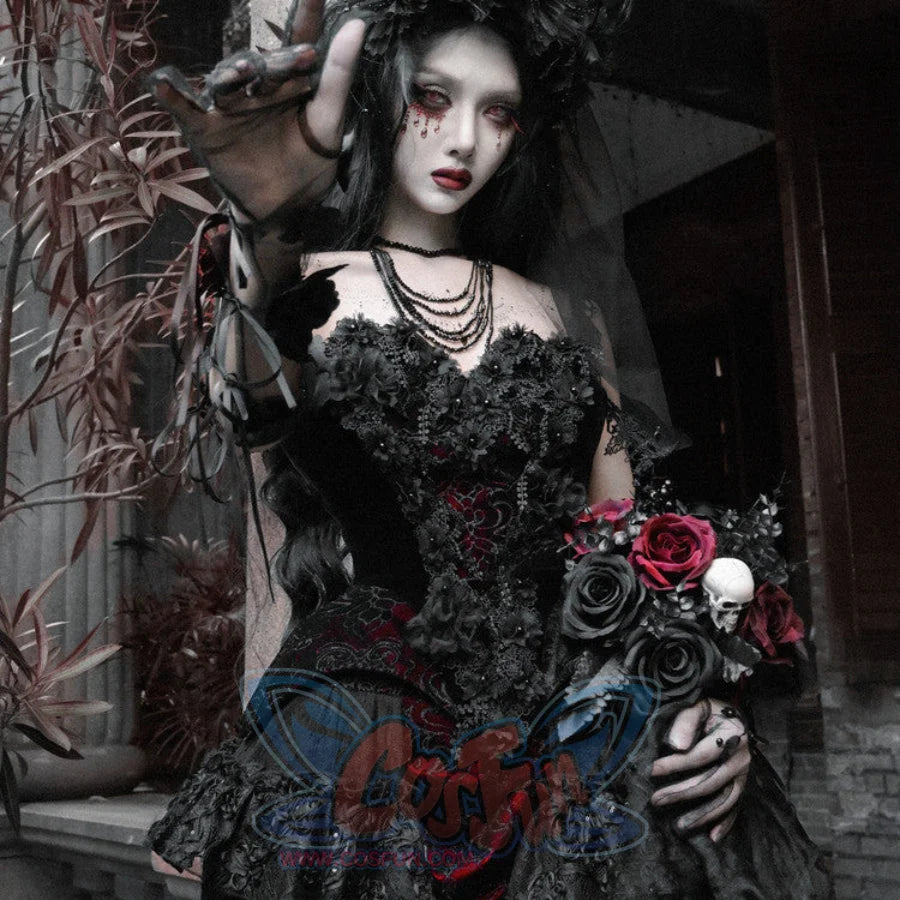 Model in black velvet corset bustier top with red brocade holding a gothic bouquet of black and red roses with skull charm.