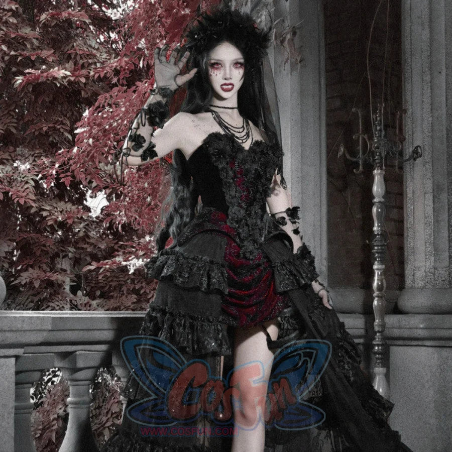 Model in gothic black velvet corset bustier top with red brocade mini skirt, ruffled layers, floral crown, and lace gloves.