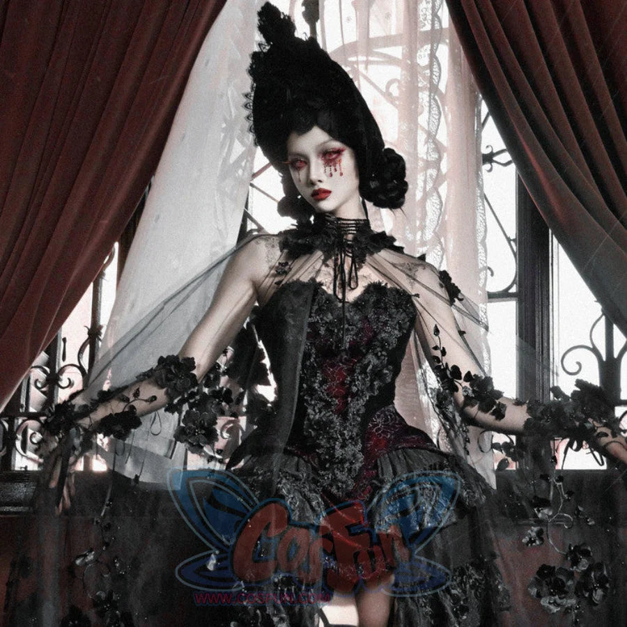 Model wearing gothic black velvet corset bustier top with red brocade, sheer veil, black floral arm accents, and dark crown.