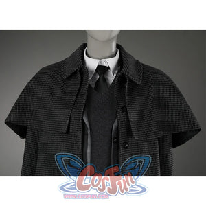 The coat has a unique design with shawl-like details on the shoulders. The fabric looks textured and has a plaid pattern, giving it a retro feel.
