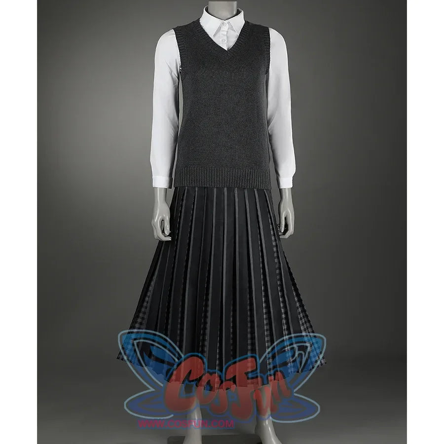 A knitted vest and a collared shirt give the overall style a formal feel, paired with a black pleated long skirt.