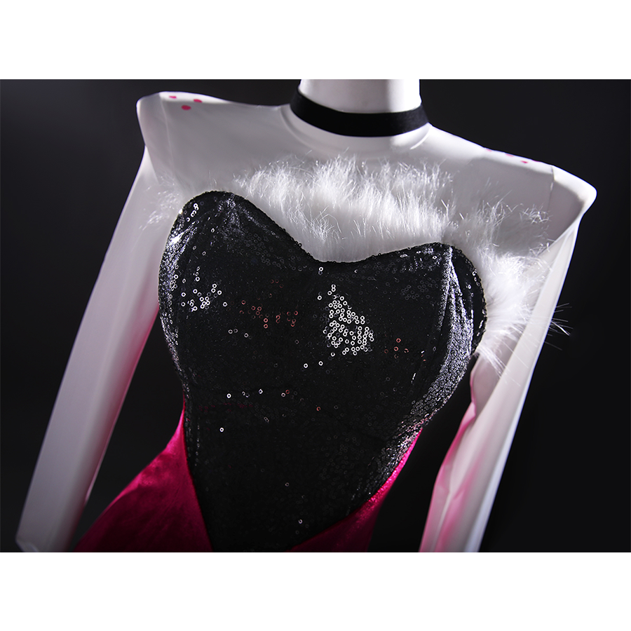The upper part of the dress is made of sequin fabric and decorated with feather accents.