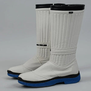 White motorcycle boots with black and blue soles on a gray background