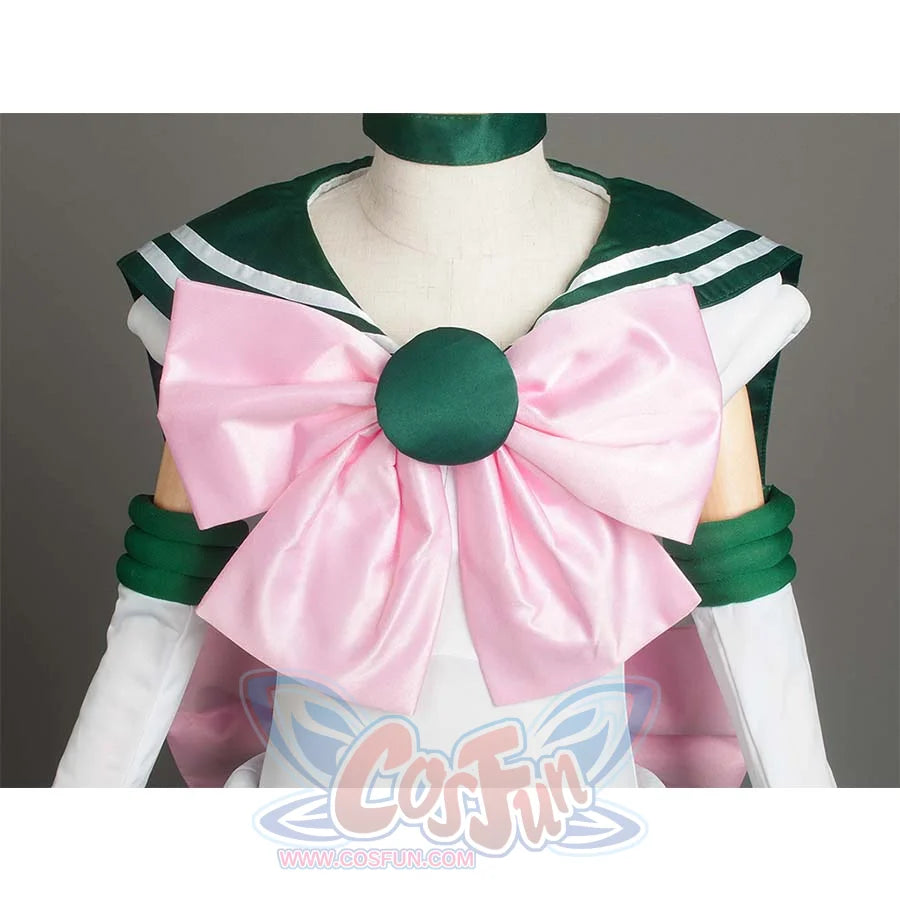 Close - up of the large pink bow with a green round center on the front of the costume, showcasing decorative details.