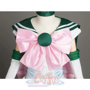 Close - up of the large pink bow with a green round center on the front of the costume, showcasing decorative details.