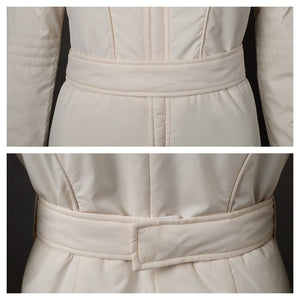 Features the belt of the beige jumpsuit. Shows front and back views of the belt’s design and how it fastens.