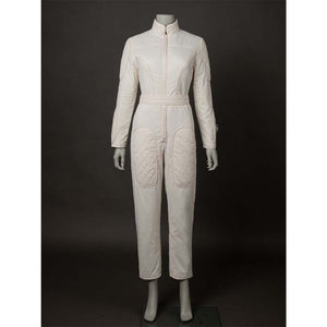 Front view of the beige jumpsuit alone, featuring a belted waist and quilted pockets. Shows the jumpsuit's design without the vest.