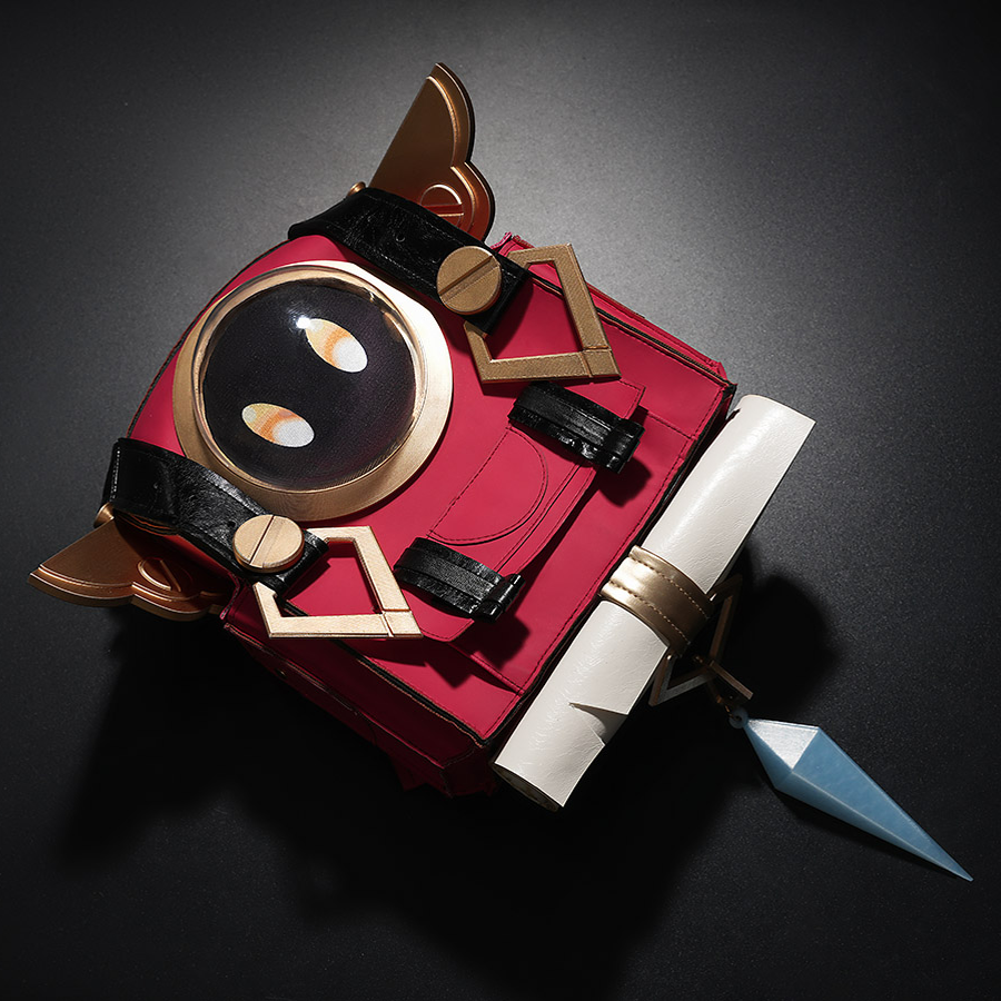 Close-up of Genshin Impact Linnea cosplay red backpack featuring Nod-Krai face design and gold hardware on dark background