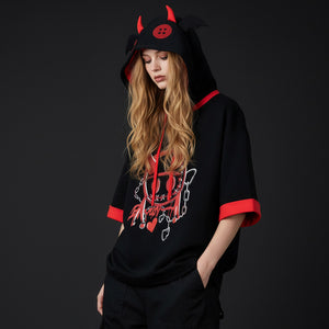 Woman wearing black summer little devil short sleeve hooded sweatshirt with red horns and design