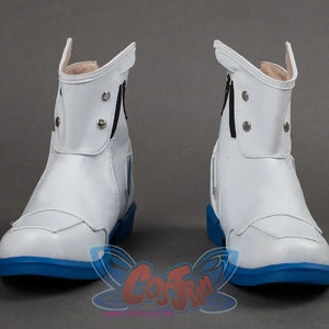 Side view highlighting white leather texture, blue sole contrast, black strap details, and metal button accents