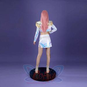 From the back, the Mira cosplay reveals the jacket’s blue patterns, gold - adorned epaulets, and the skirt’s detailed blue designs, with beige boots, set against a purple backdrop.