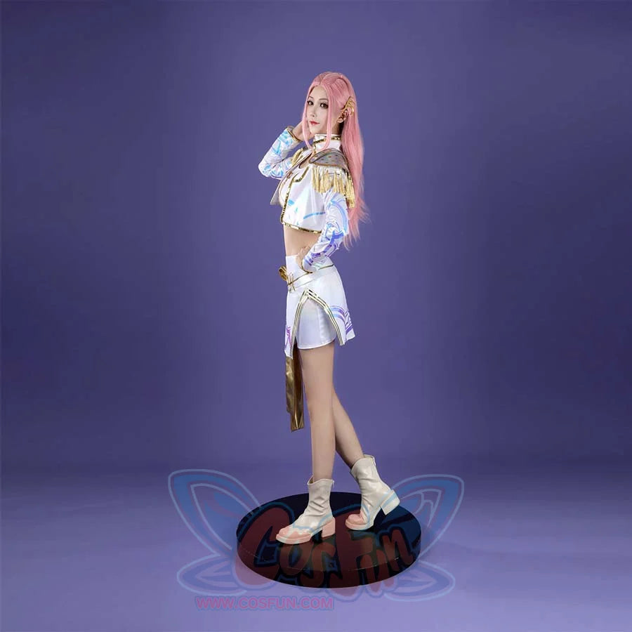 The side view highlights the Mira costume’s cropped jacket with gold trim, blue - patterned sleeves, and the skirt’s mix of white, blue patterns, and gold accents, all paired with beige boots on a purple background.