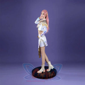 The side view highlights the Mira costume’s cropped jacket with gold trim, blue - patterned sleeves, and the skirt’s mix of white, blue patterns, and gold accents, all paired with beige boots on a purple background.