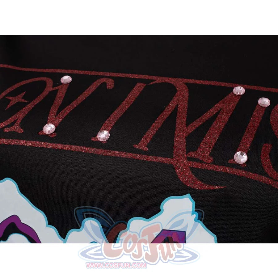 Close - up of red glittery text with pink gems on Mira’s black cosplay top.