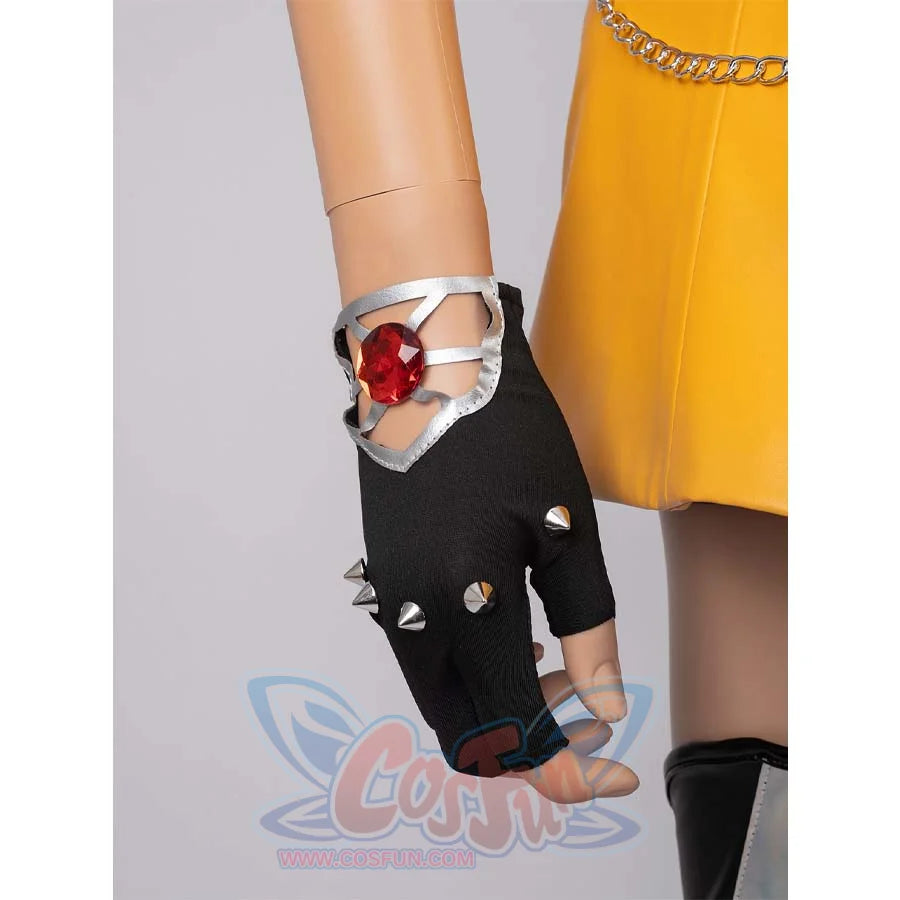 Close - up of a black spiked glove with a red gem, part of Mira’s cosplay costume.