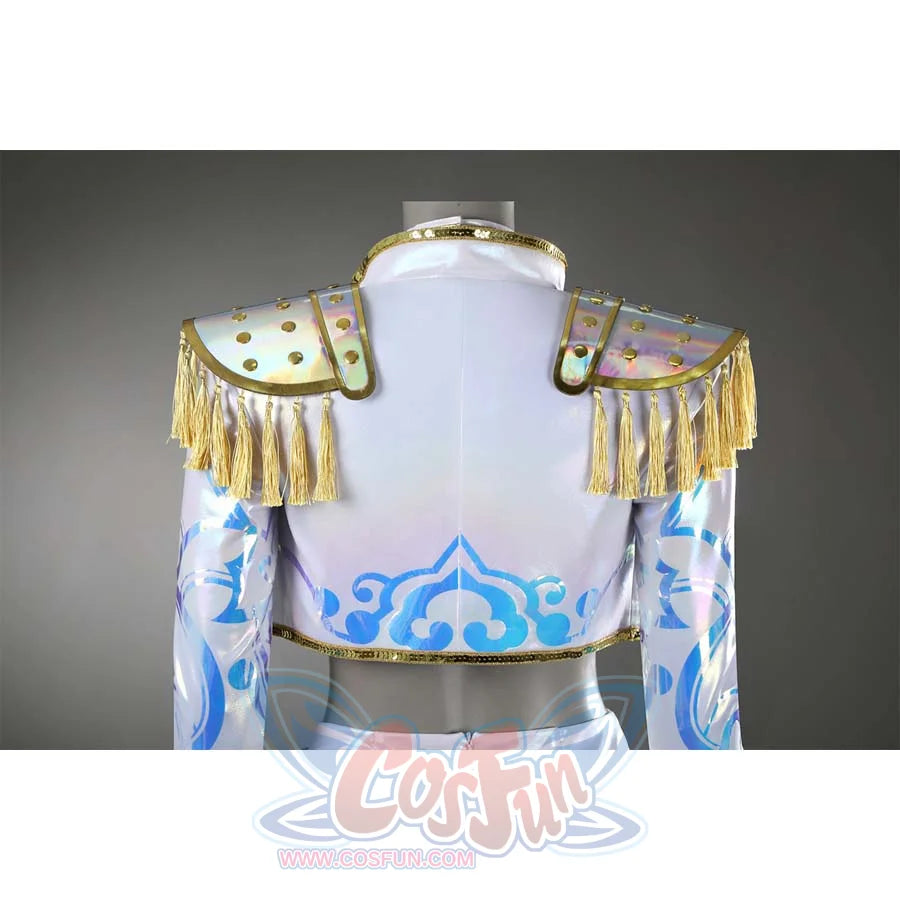 The back of the cropped jacket draws focus to its iridescent epaulets, where gold tassels sway gently, paired with blue geometric patterns that climb up the sleeves.